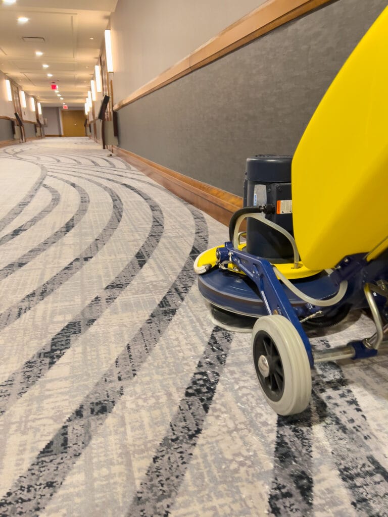 Vacuum cleaner on freshly cleaned commercial carpet