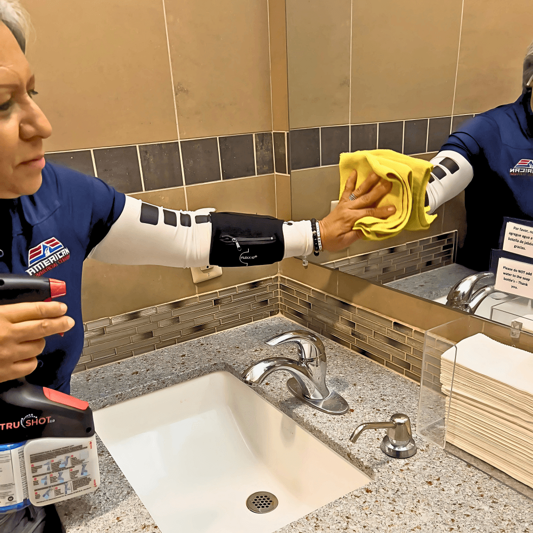 Day porter cleaning a mirror to maintain a spotless and welcoming commercial space.