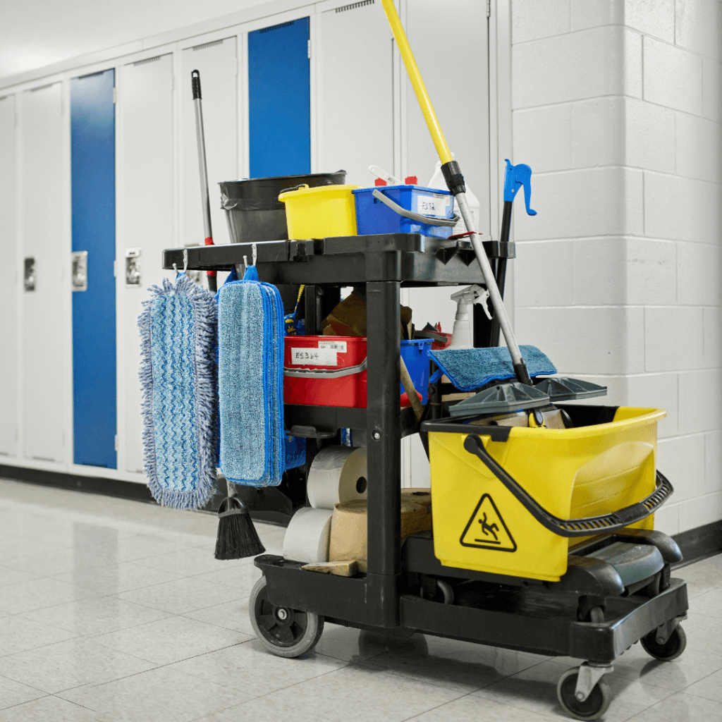 Janitorial trolley positioned in front of school lockers for easy cleaning access